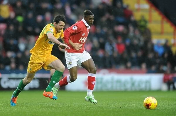 Bristol City vs Yeovil Town: Intense Battle for the Ball - Kieran Agard vs Brendan Moloney