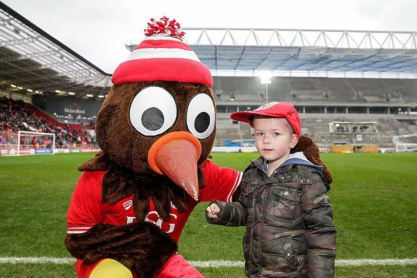 Bristol City: Young Fan Receives Cap from Scrumpy the Mascot at Ashton Gate Stadium
