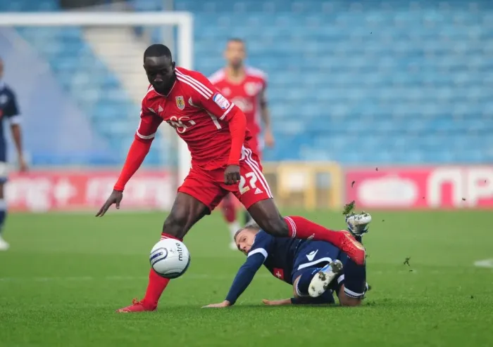 Framed Print : Bristol City's Albert Adomah Dodges Brian Howard's Challenge: Millwall vs. Bristol City, Championship 2011 - Editorial Use Only