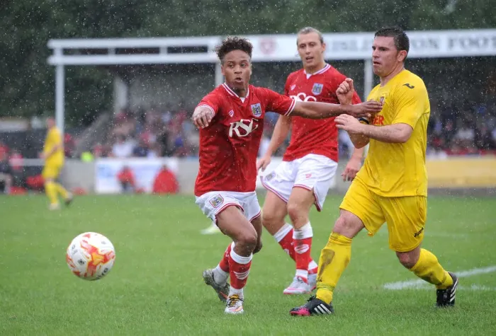 Framed Print : Bristol City's Bobby Reid Faces Off Against Brislington's James Peart in Pre-Season Clash Framed Print : Bristol City's Bobby Reid Faces Off Against Brislington's James Peart in Pre-Season Clash