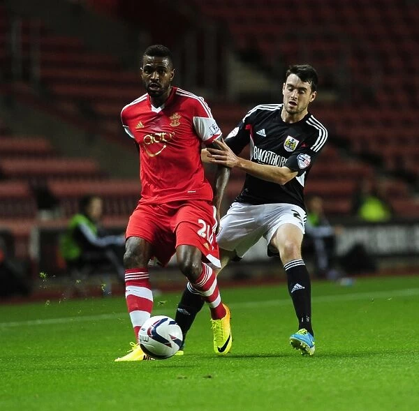 Bristol City's Brendan Moloney Closes In on Southampton's Guilherme do Prado in Intense Capital One Cup Clash