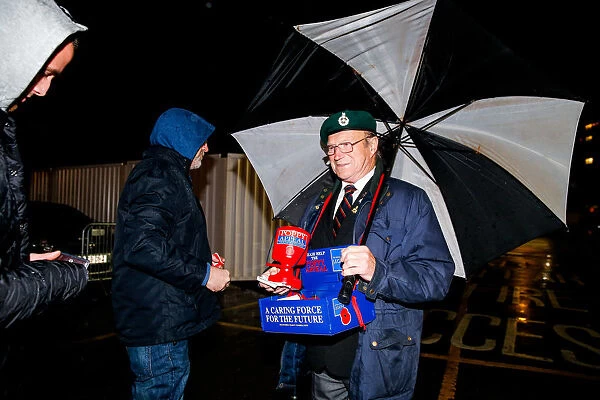 Bristol City's Buster Footman Braves the Rain for Poppy Appeal Donations at Ashton Gate Stadium