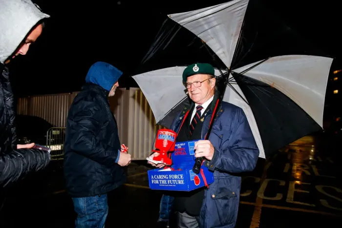 Framed Print : Bristol City's Buster Footman Braves the Rain for Poppy Appeal Donations at Ashton Gate Stadium Framed Print : Bristol City's Buster Footman Braves the Rain for Poppy Appeal Donations at Ashton Gate Stadium