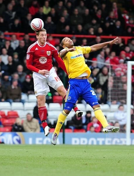 Bristol City's Christian Ribeiro Outmuscles Luke Moore in Championship Clash: Bristol City vs Derby County (11-12-2010)