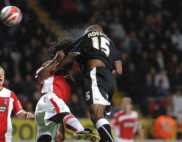 Bristol City's Dele Adebola Battles Charlton's Linvoy Primus for Ball Possession