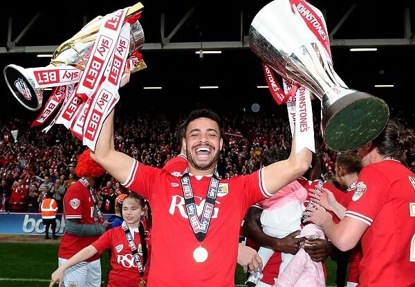 Bristol City's Derrick Williams Lifts Double: Sky Bet League One and JPT Trophies after Winning Championship Game against Walsall (May 2015)