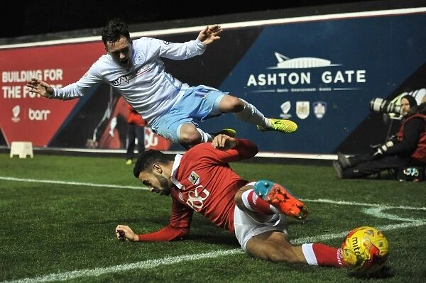 Bristol City's Derrick Williams Tackles Coventry City's Danny Swanson: A Moment from the Johnstones Paint Trophy Match at Ashton Gate Stadium