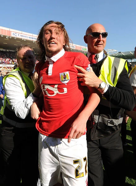 Bristol City's Euphoric Celebrations: Luke Ayling Led Back After Fans Invade Pitch to Secure League One Victory