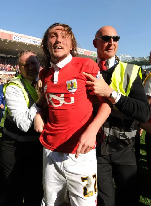 Framed Print : Bristol City's Euphoric Celebrations: Luke Ayling Led Back After Fans Invade Pitch to Secure League One Victory Framed Print : Bristol City's Euphoric Celebrations: Luke Ayling Led Back After Fans Invade Pitch to Secure League One Victory