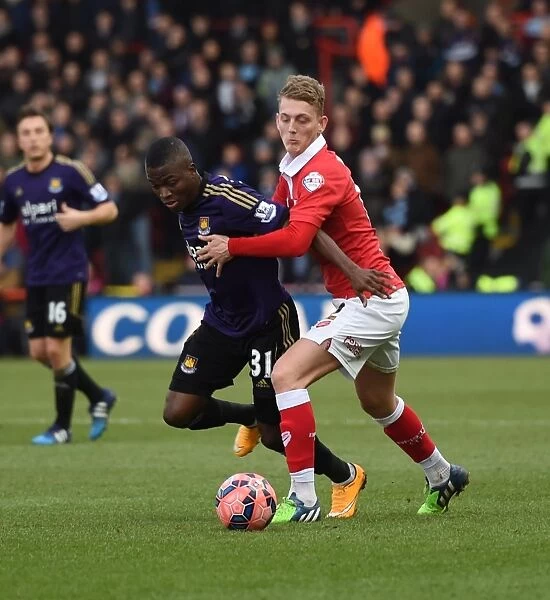 Bristol Citys George Saville tussles with West Hams Enner Valencia in the FA Cup