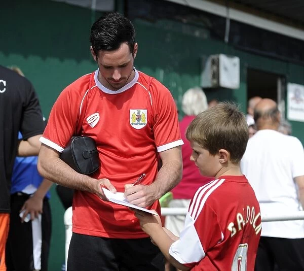 Bristol City's Greg Cunningham Connects with a Young Fan at Portishead Town Pre-Season Friendly