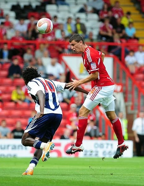 Bristol City's James Wilson Outmuscles Somen Tchoyi in High Ball Clash: Championship Showdown between Bristol City and West Brom, 2011
