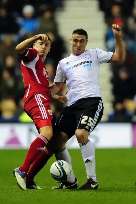 Framed Print : Bristol City's James Wilson vs Callum Ball in Championship Clash at Derby County, 10 / 12 / 2011