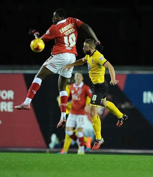 Bristol City's Jay Emmanuel-Thomas Battles for High Ball Against AFC Wimbledon's Sammy Moore during Johnstone's Paint Trophy Match