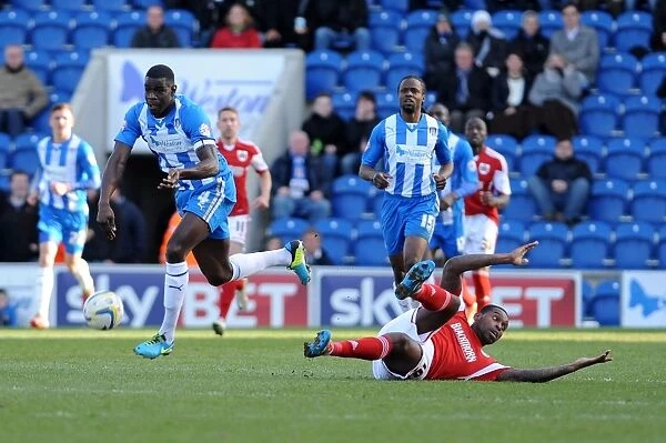 Bristol City's Jay Emmanuel-Thomas Contests the Ball with Colchester United's Magnus Okuonghae - Football Rivalry in League One