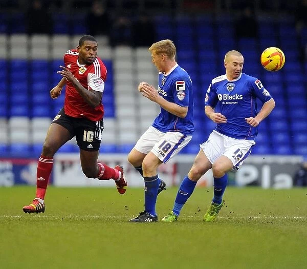 Bristol City's Jay Emmanuel-Thomas Fights for Possession against Oldham Athletic's Lockwood and Mellor
