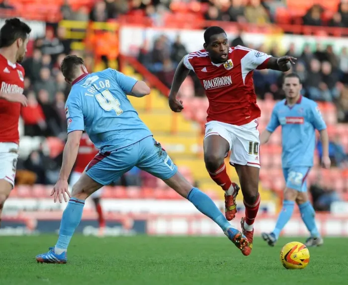 Framed Print : Bristol City's Jay Emmanuel-Thomas Leaps Past Ash Taylor of Tranmere Rovers in Sky Bet League One Clash