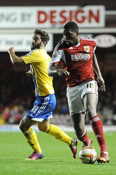 Bristol City's Jay Emmanuel-Thomas Outmaneuvers Brentford's Will Grigg in Sky Bet League One Clash