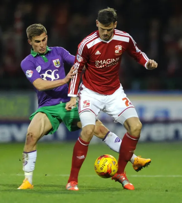 Framed Print : Bristol City's Joe Bryan Closes In on Swindon Town's Ben Gladwin during Sky Bet League One Match Framed Print : Bristol City's Joe Bryan Closes In on Swindon Town's Ben Gladwin during Sky Bet League One Match