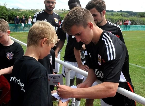 Bristol City's Joe Bryan Connects with Young Fan at Portishead Town Pre-Season Friendly