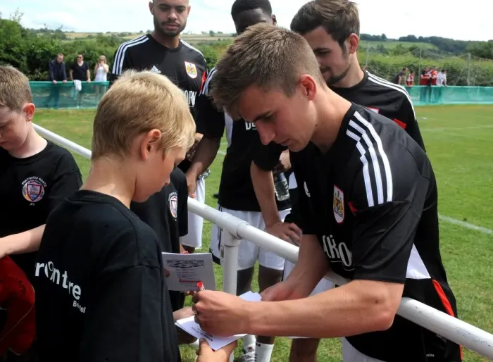 Framed Print : Bristol City's Joe Bryan Connects with Young Fan at Portishead Town Pre-Season Friendly Framed Print : Bristol City's Joe Bryan Connects with Young Fan at Portishead Town Pre-Season Friendly
