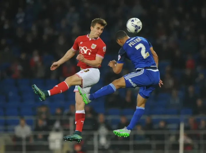 Framed Print : Bristol City's Joe Bryan Contests Header Against Cardiff City's Lee Peltier in Championship Clash
