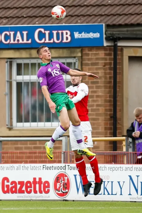 Framed Print : Bristol City's Joe Bryan and Fleetwood Town's Conor McLaughlin Battle for Aerial Supremacy in Fleetwood Town v Bristol City Football Match, Sky Bet League 1, Highbury Stadium, 2014