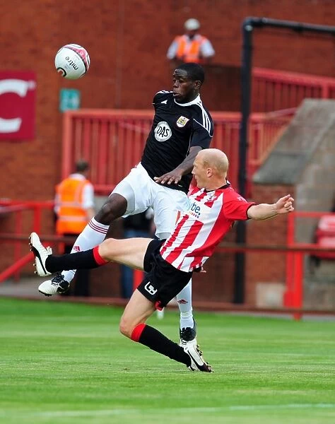 Bristol Citys John Akinde battles for the ball with Rob Edwards
