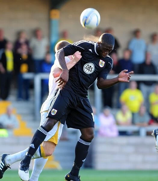Bristol Citys John Akinde challenges for the ariel ball