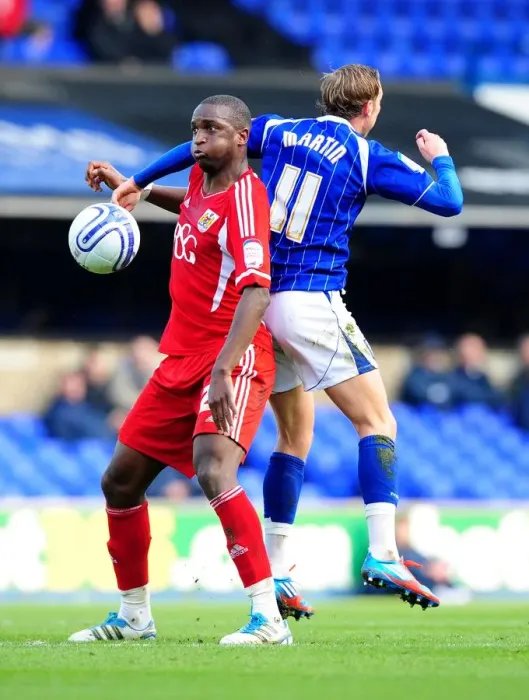Framed Print : Bristol City's Kalifa Cisse vs. Ipswich Town's Lee Martin: Intense Battle for Ball Possession during Ipswich Town v Bristol City Football Match, Portman Road, England, 2012