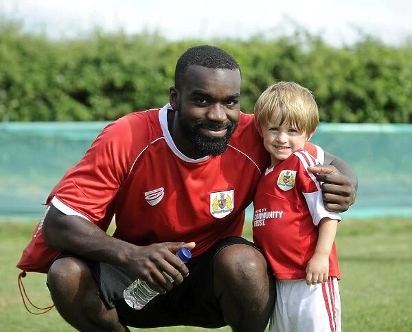 Bristol City's Karleigh Osborne and Young Fan Share a Moment at Portishead Town's The Playing Fields