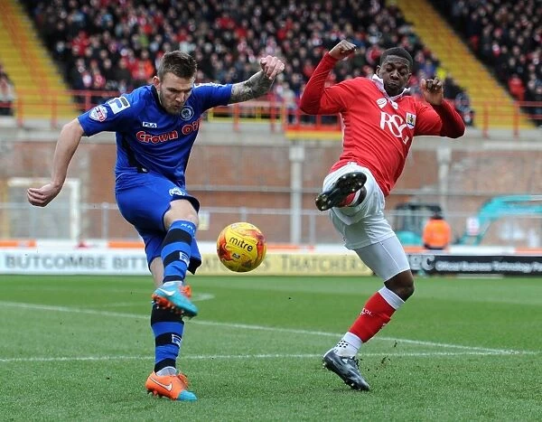 Bristol City's Kieran Agard Closes In on Rochdale's Ashley Eastham in Intense Football Action