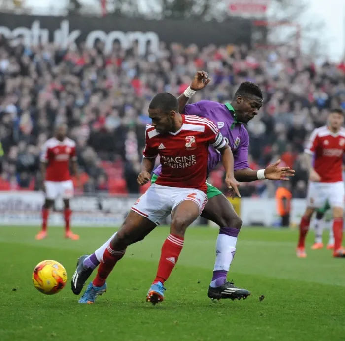 Framed Print : Bristol City's Kieran Agard Closes In on Swindon Town's Nathan Thompson in Sky Bet League One Clash Framed Print : Bristol City's Kieran Agard Closes In on Swindon Town's Nathan Thompson in Sky Bet League One Clash