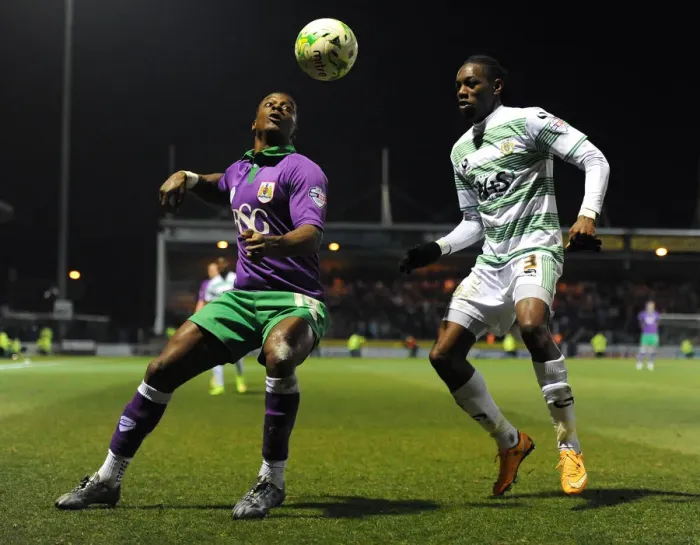 Framed Print : Bristol City's Kieran Agard Closes In on Yeovil Town's Nathan Smith in Sky Bet League One Clash Framed Print : Bristol City's Kieran Agard Closes In on Yeovil Town's Nathan Smith in Sky Bet League One Clash