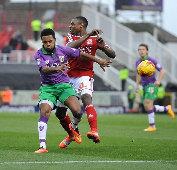 Bristol City's Korey Smith Closes In on Swindon Town's Jonathan Obika in Sky Bet League One Clash