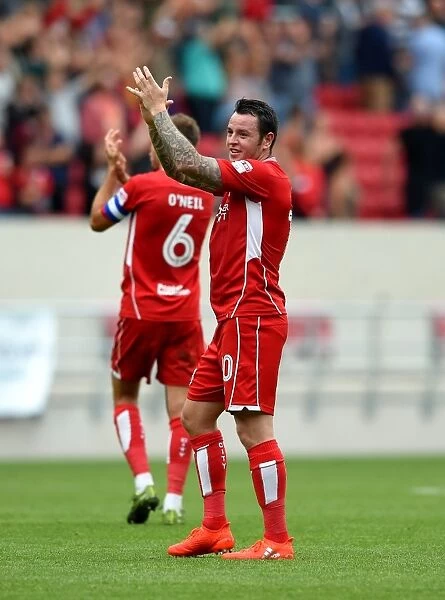 Bristol City's Lee Tomlin Celebrates with Fans After Win Against Aston Villa