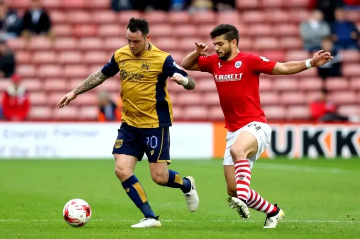 Framed Print : Bristol City's Lee Tomlin Faces Off Against Barnsley's Sam Morsy in Sky Bet Championship Clash Framed Print : Bristol City's Lee Tomlin Faces Off Against Barnsley's Sam Morsy in Sky Bet Championship Clash
