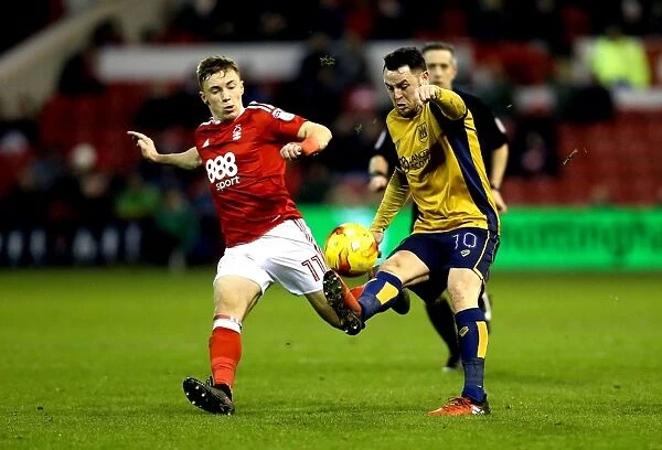 Bristol City's Lee Tomlin Fends Off Nottingham Forest's Ben Osborn in Championship Clash