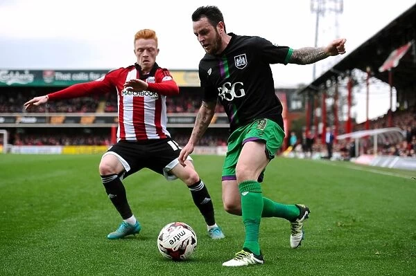 Bristol City's Lee Tomlin Fights Off Pressure from Brentford's Ryan Woods during Sky Bet Championship Match