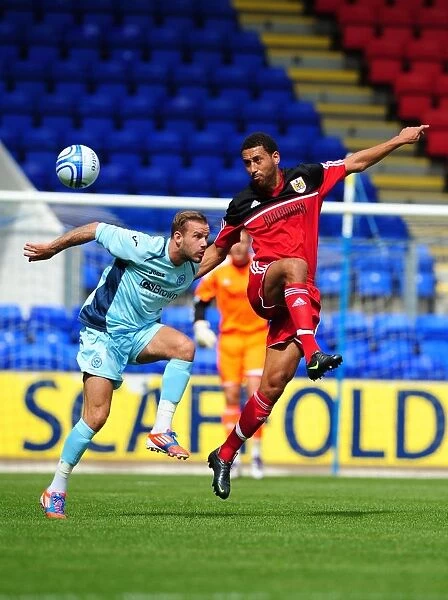 Bristol City's Lewin Nyatanga Battles for the High Ball in Pre-Season Friendly against St Johnstone