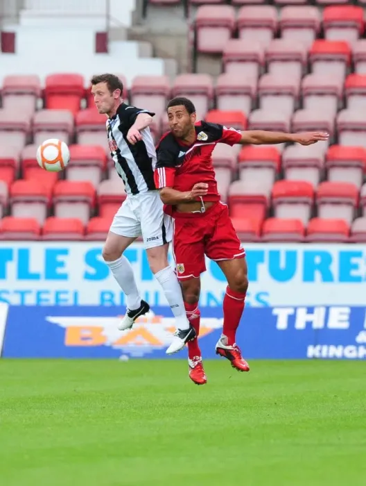 Framed Print : Bristol City's Lewin Nyatanga vs. Andy Kirk: Aerial Battle in Dunfermline Friendly Framed Print : Bristol City's Lewin Nyatanga vs. Andy Kirk: Aerial Battle in Dunfermline Friendly