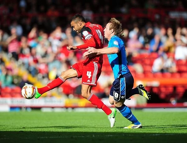 Bristol City's Liam Fontaine Clears Ball from Luciano Becchio in Championship Clash