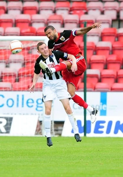 Bristol City's Liam Fontaine Fights for Ball Against Dunfermline's Paul Willis in Pre-Season Friendly