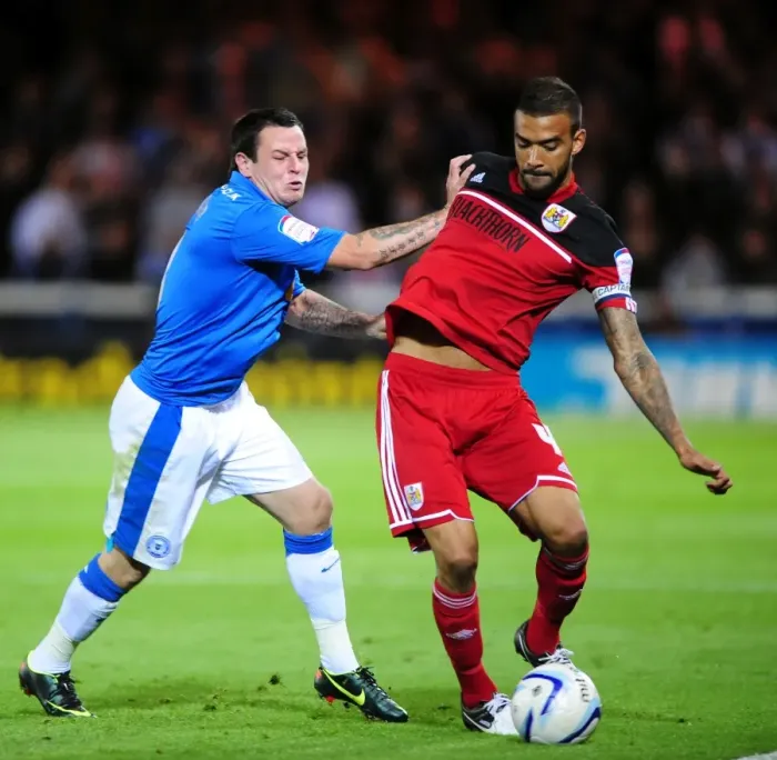 Framed Print : Bristol City's Liam Fontaine Foul by Lee Tomlin in Peterborough United Championship Clash Framed Print : Bristol City's Liam Fontaine Foul by Lee Tomlin in Peterborough United Championship Clash