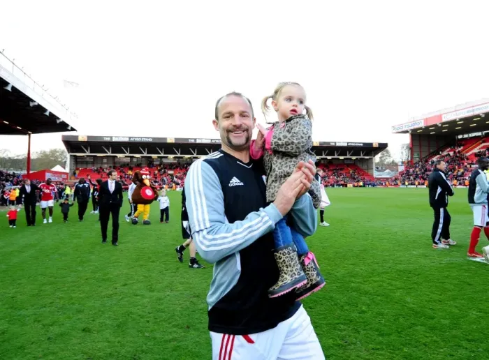 Framed Print : Bristol City's Louis Carey and Daughter Share Special Moment at Ashton Gate Stadium during Bristol City v Barnsley Match Framed Print : Bristol City's Louis Carey and Daughter Share Special Moment at Ashton Gate Stadium during Bristol City v Barnsley Match