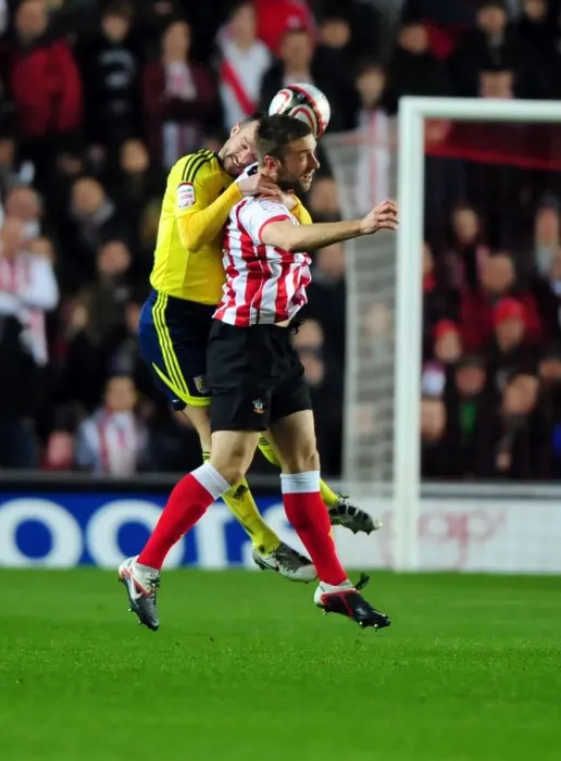 Framed Print : Bristol City's Louis Carey vs. Rickie Lambert: A Battle for Supremacy in the Championship Clash between Southampton and Bristol City (December 30, 2011)