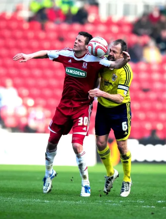 Framed Print : Bristol City's Louis Carey vs. Middlesbrough's Lukas Jutkiewicz: A Battle for Supremacy in the Riverside Stadium Air (Middlesbrough v Bristol City, 2012)