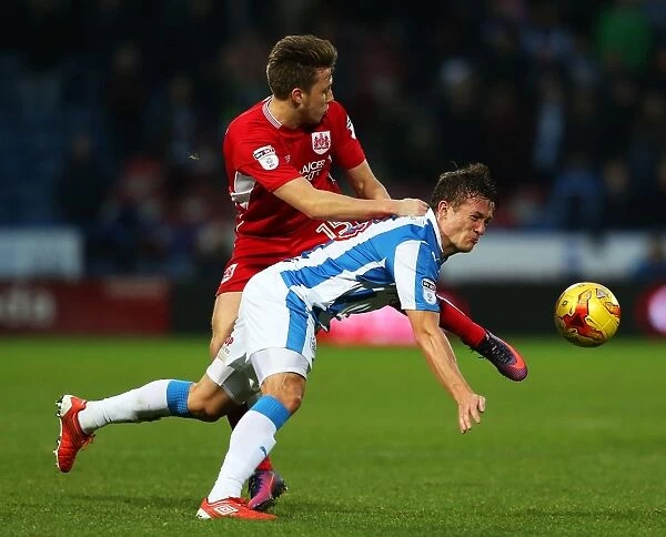 Bristol City's Luke Freeman Faces Off Against Huddersfield Town's Jonathan Hogg in Championship Clash