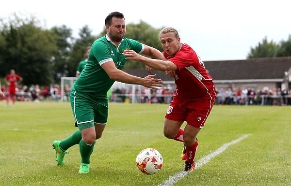 Bristol City's Luke Freeman Faces Off Against Hengrove Athletic's Luke Crewe in Pre-Season Friendly