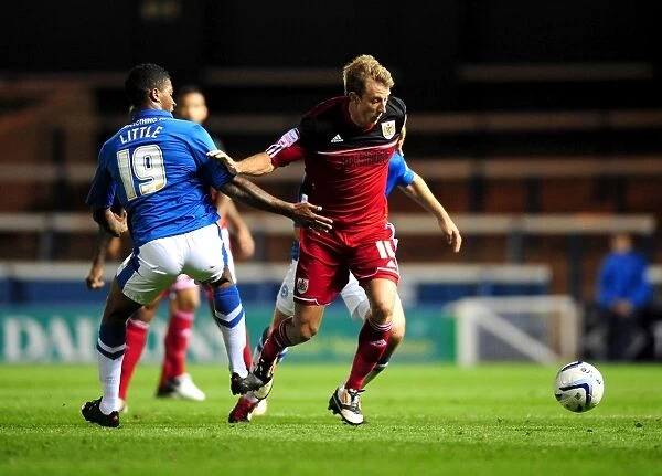 Bristol City's Martyn Woolford Dribbles Past Peterborough United's Mark Little in Championship Clash